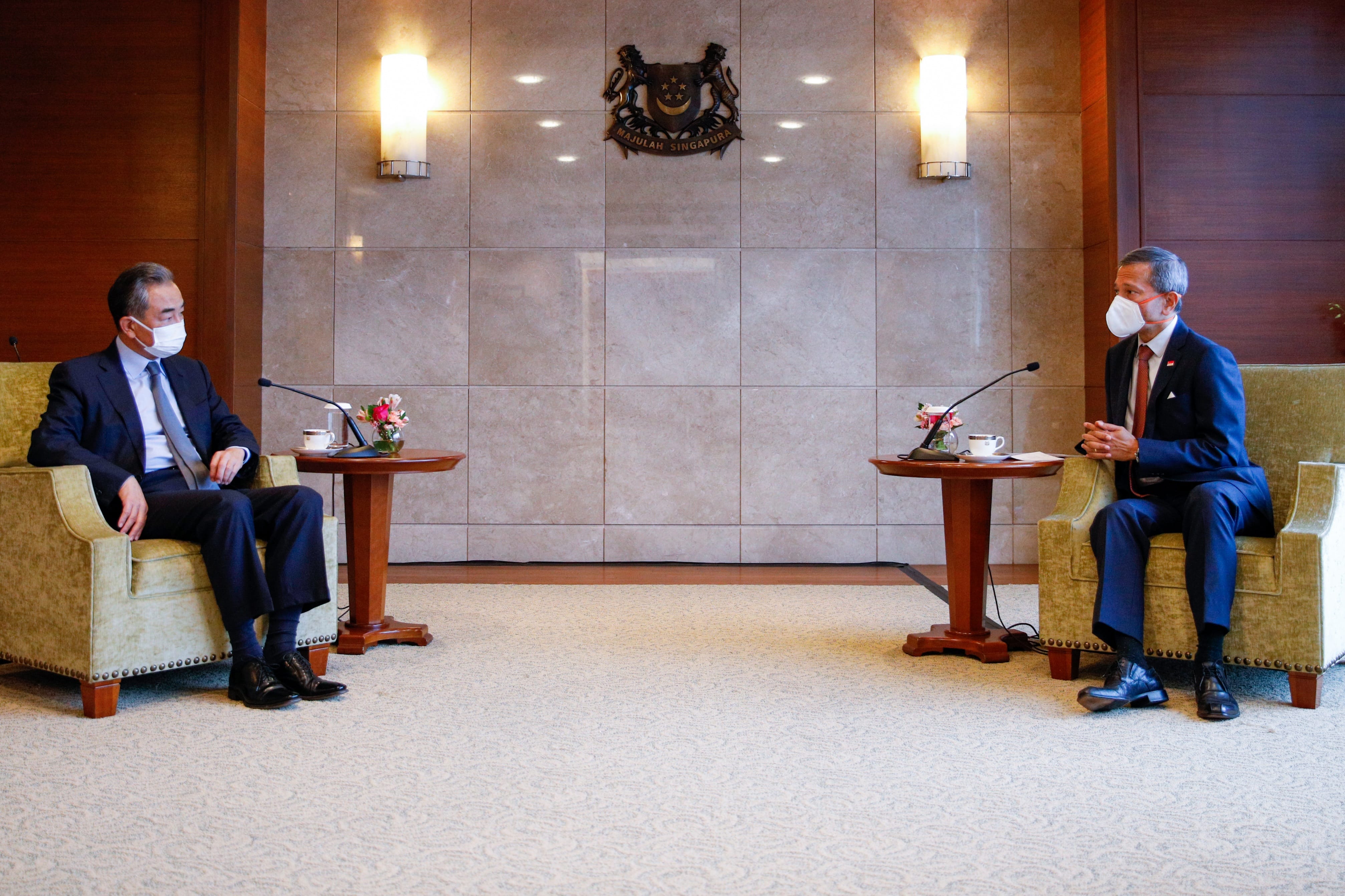 Group of seven people in business attire, standing beneath the "ERBER Group" logo and monitors showing produce.